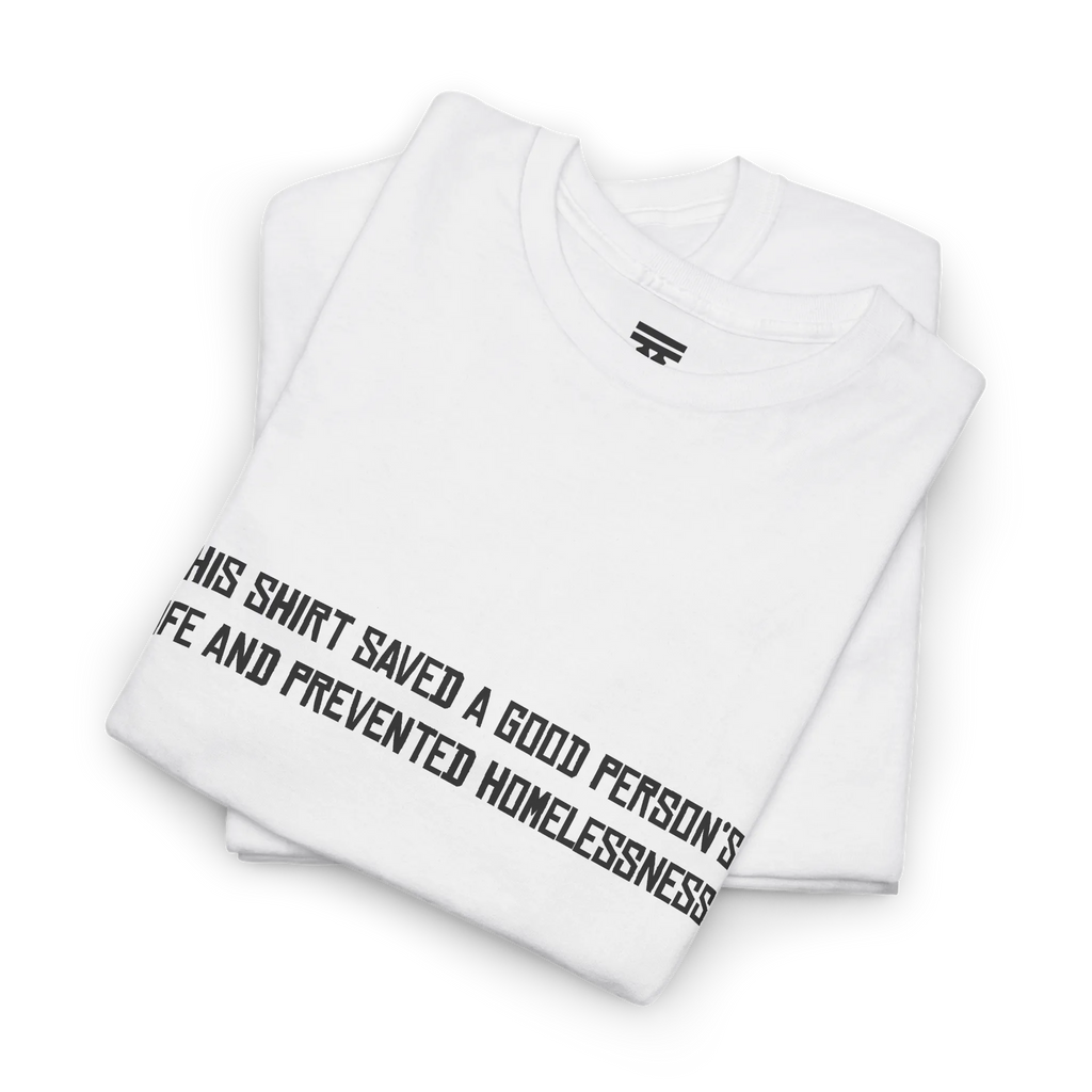 White cotton t-shirt folded in a stack with the black printed front text visible at an angle.