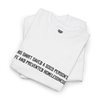 White cotton t-shirt folded in a stack with the black printed front text visible at an angle.