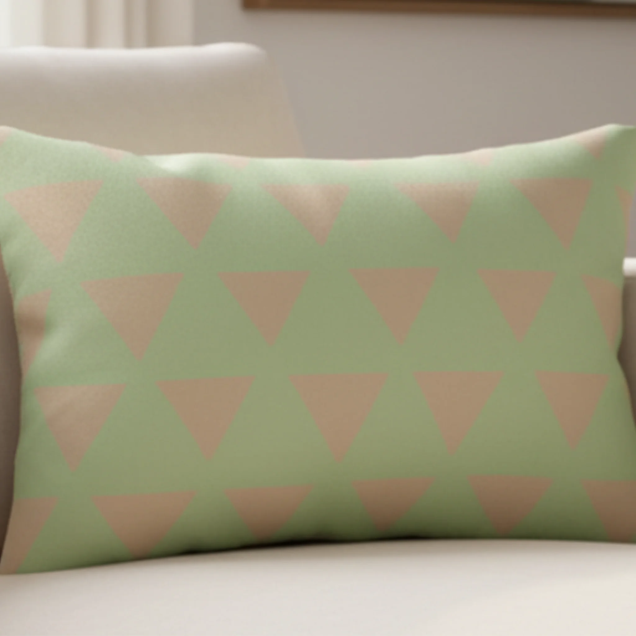 Schist Green triangle lumbar pillow styled on a couch in a modern living room.