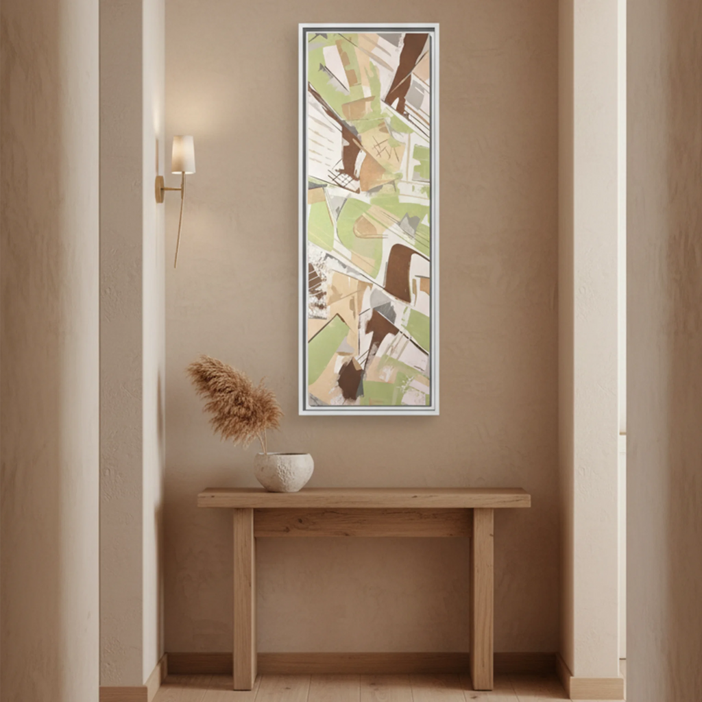 "Slim Sage" Tall Framed Canvas Art by FREEBRD — sage green abstract vertical canvas styled in a warm residential hallway above a console table, natural home setting, earthy minimalist decor.
