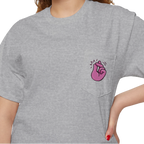 A person wearing a FREEBRD sport grey classic cotton pocket t-shirt with a baby pink cartoon finger-snap Clock It graphic printed on the front chest pocket.