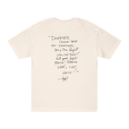 Classic fit crew neck tee, cream, back view, handwritten script quote reading Darkness cannot drive out darkness only the light can do that let your light shine Spread Love Not Hate with signature.