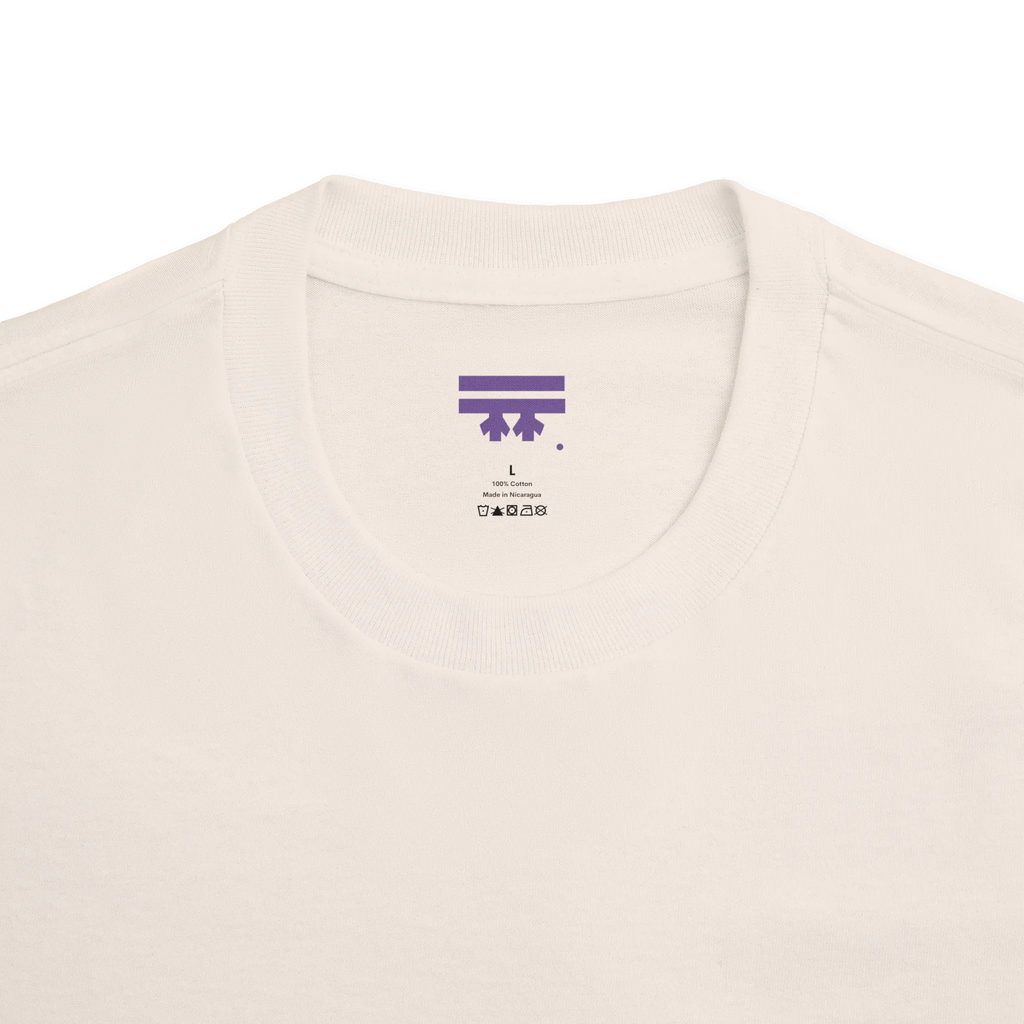 Classic fit crew neck tee, cream, collar close-up showing FREEBRD brand label, 100% cotton.