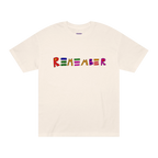 Classic fit crew neck tee, cream, front view, hand-drawn multicolor lettering reading REMEMBER in red, blue, green, orange, purple, and pink.