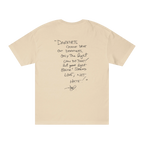 Classic fit crew neck tee, sand, back view, handwritten script quote reading Darkness cannot drive out darkness only the light can do that let your light shine Spread Love Not Hate with signature.