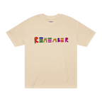 Classic fit crew neck tee, sand, front view, hand-drawn multicolor lettering reading REMEMBER in red, blue, green, orange, purple, and pink.