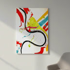 Freebrd "Stripe Status" unframed vibrant abstract canvas art, 30x40 vertical, 1.25" thick white-wrapped edges, hung on clean white wall beside accent chair for size reference — bold black brushstroke curve, red, yellow, teal, and hot pink abstract composition.