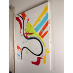 Angled view of an abstract acrylic painting showing the canvas depth, handwritten FREEBRD artist name Jasmine Jackson Artwork along the edge, and colorful marks across a white ground.