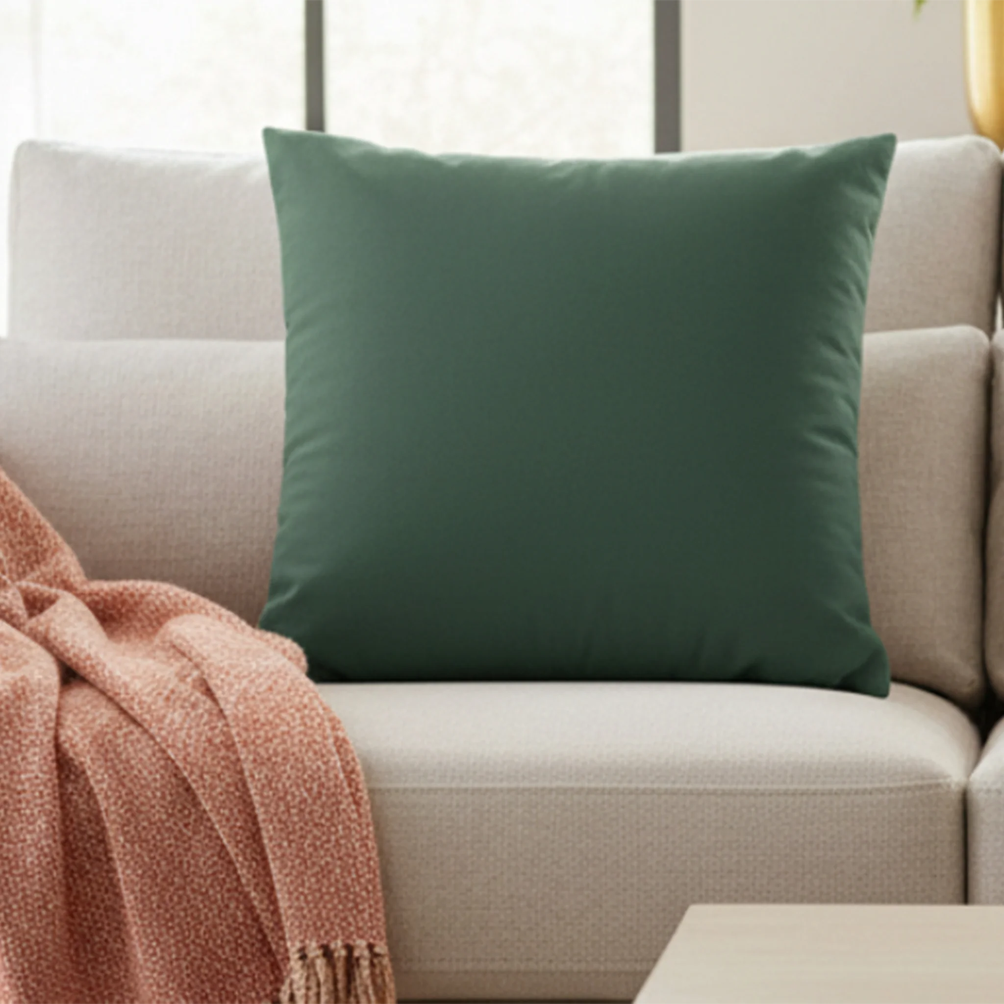 Stromboli Green faux suede pillow styled on a couch in a modern living room.