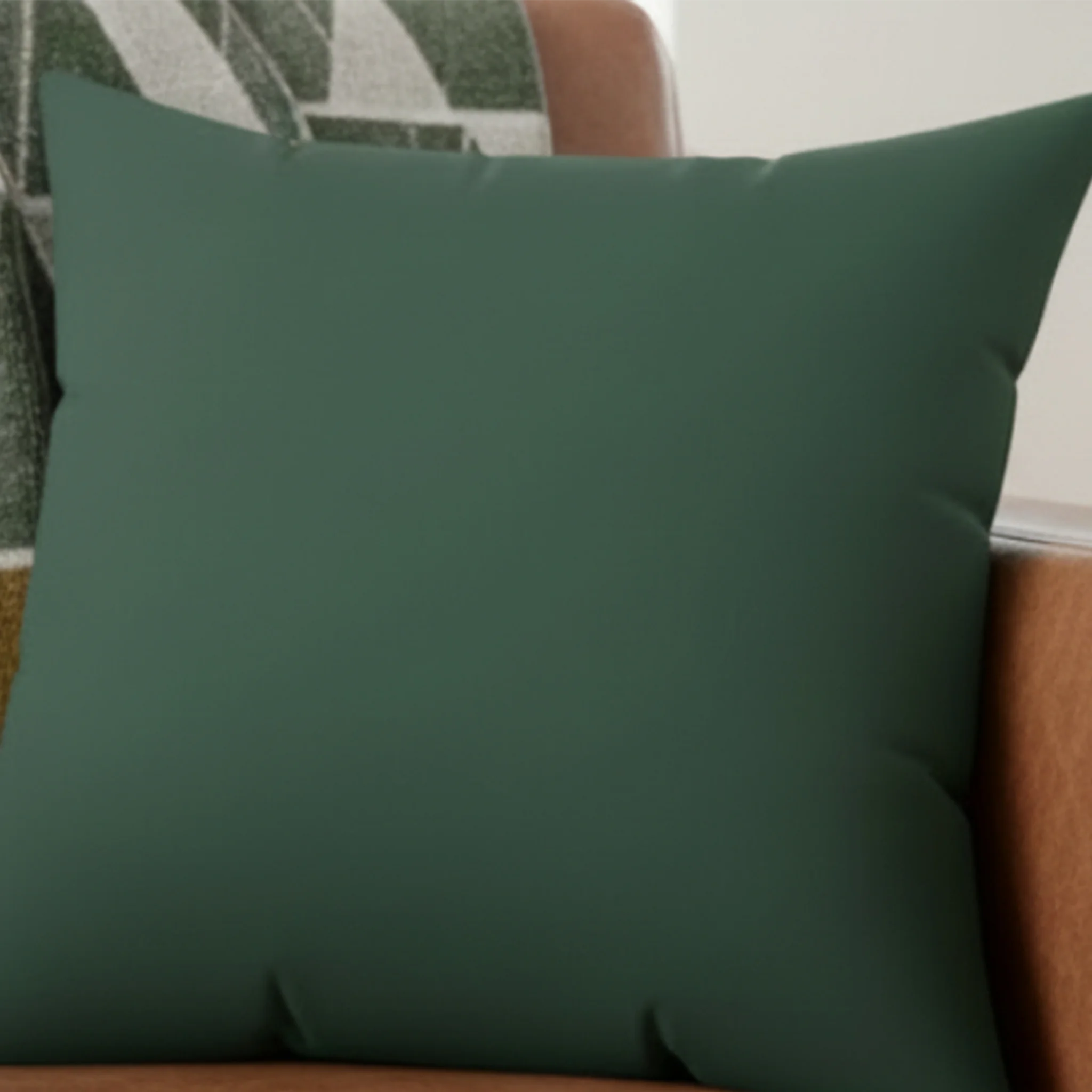 Stromboli green faux suede throw pillow styled in living room, lifestyle view.