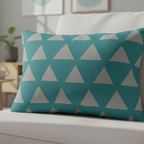 Teal stardust grey geometric triangle lumbar pillow styled on a sofa chair in a modern living room. 