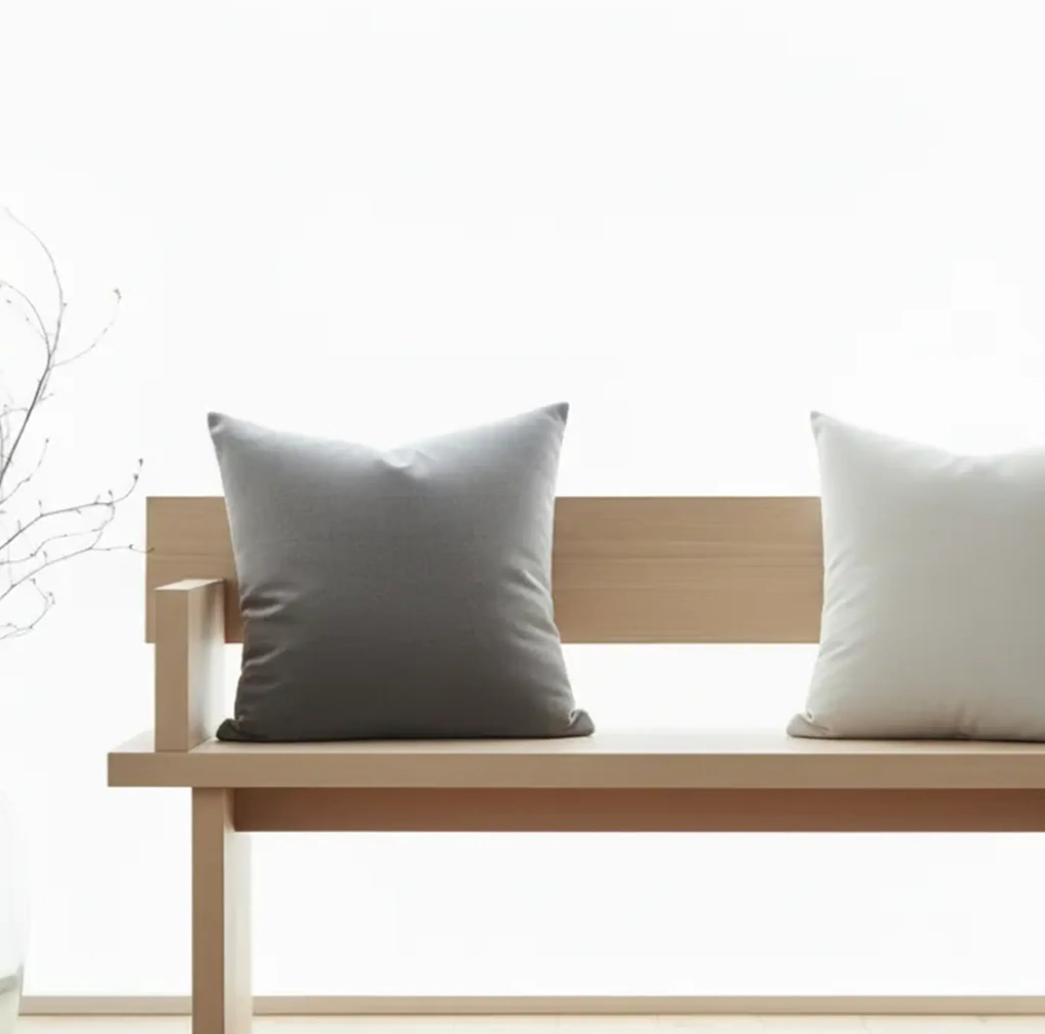 a nordic minimalist hallway scene with two pillows on a wooden bench with a bright, beautiful, minimal background.