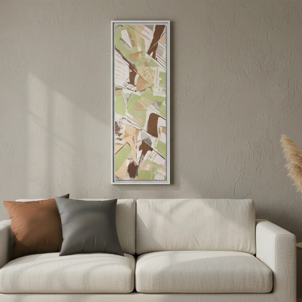 White framed Slim Sage abstract canvas art above cream linen sofa, Saddle Brown and Atomic Grey faux suede pillows, minimalist living room lifestyle.