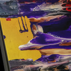 Close-up texture detail of "Tribal Wave" framed abstract canvas by FREEBRD — fluid pour art in purple, red, yellow and black with tribal accents on premium DTF canvas with black wood frame and archival matte finish.
