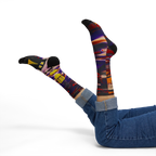 All-over print crew socks with abstract Tribal Wave art worn on legs raised, lifestyle view.
