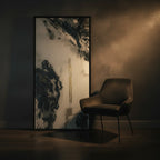 "Tu Gough" 30x60 vertical gallery-wrapped abstract canvas by FREEBRD leaning against a dark moody wall beside a contemporary velvet accent chair — size reference for large vertical abstract wall art decor.