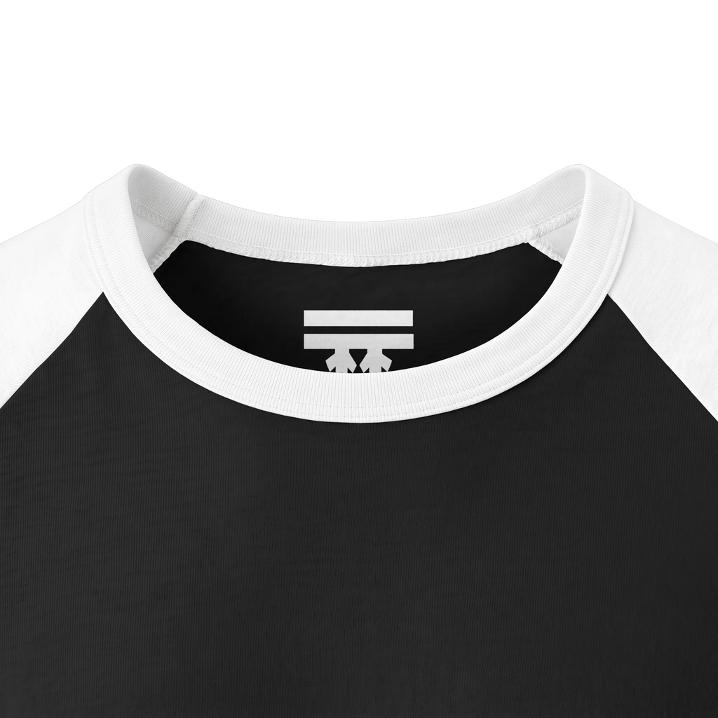 Close-up of the white collar and inner neck of a black raglan shirt, showing a white FREEBRD logo.