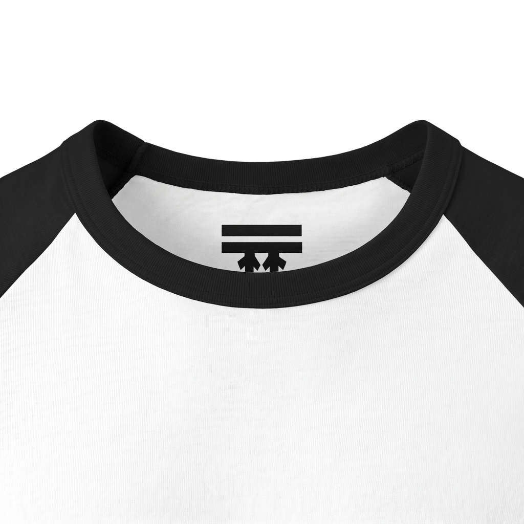 Close-up of the black collar and inner neck of a white raglan shirt, showing a black FREEBRD logo.