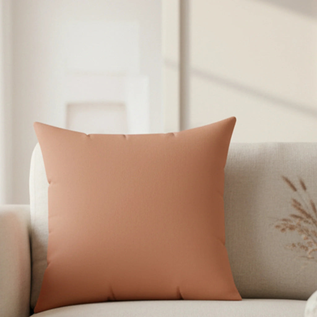 Vintage salmon faux suede throw pillow styled in living room, lifestyle view.