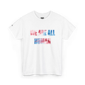 White crew neck T-shirt with ‘WE ARE ALL HUMAN’ across the chest in pink and blue watercolor-style lettering, front view.