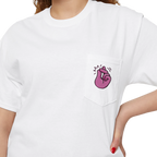 A person wearing a FREEBRD white classic cotton pocket t-shirt with a baby pink cartoon finger-snap Clock It graphic printed on the front chest pocket.