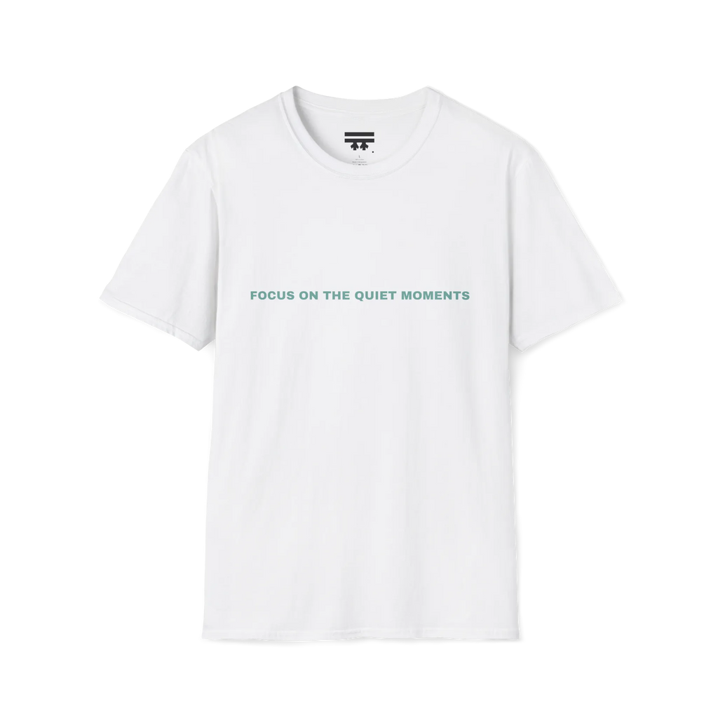 A white t-shirt with sage green Focus On The Quiet Moments text on the chest.