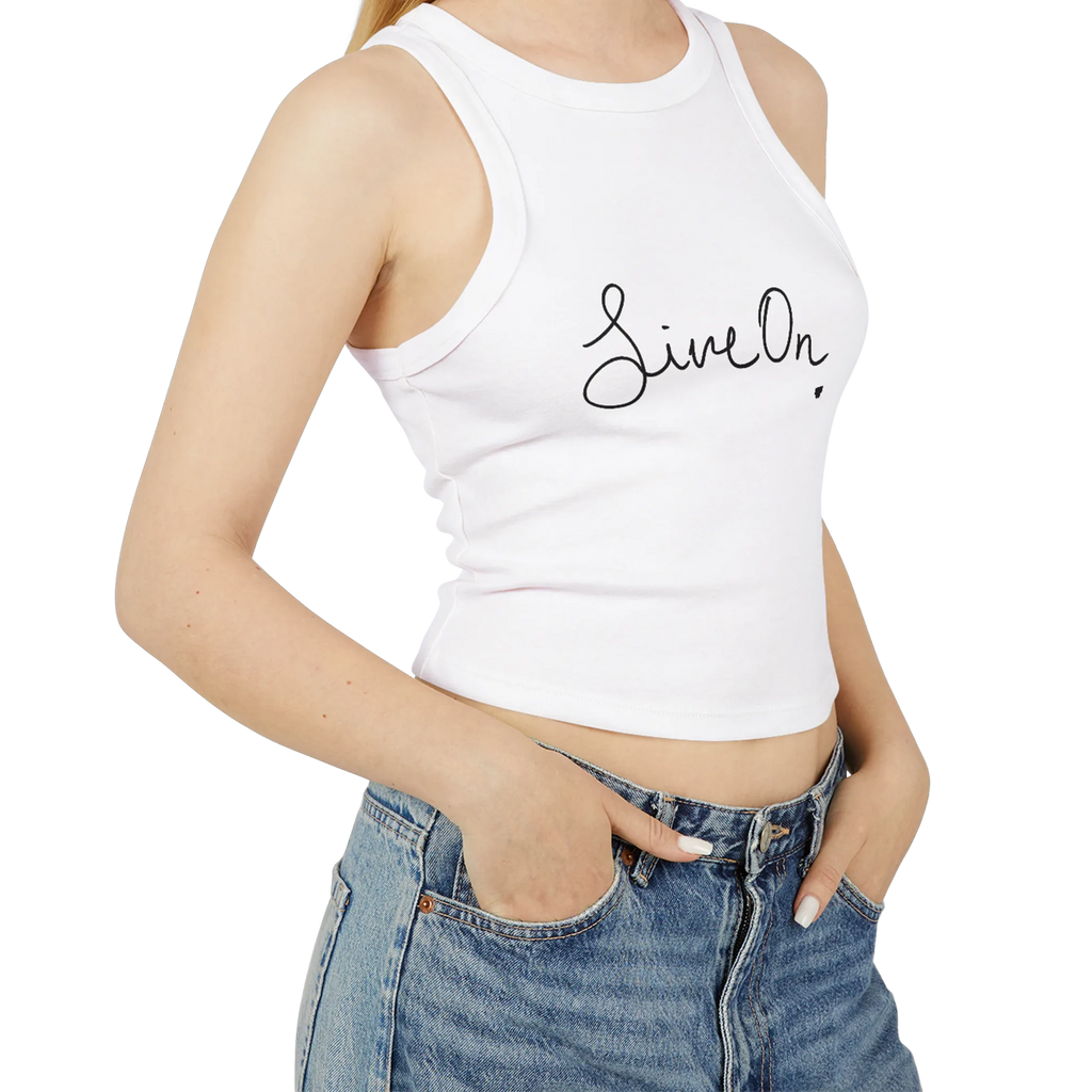 A model wearing a white cropped Live On racerback tank top paired with high-waisted denim.