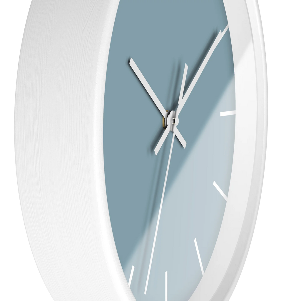 Danish blue minimalist wall clock with white wooden base, white hands, and white markers, side view.