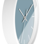 Danish blue minimalist wall clock with white wooden base, white hands, and white markers, side view.