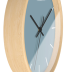 Danish blue minimalist wall clock with natural wooden base, black hands, and white markers, side view.