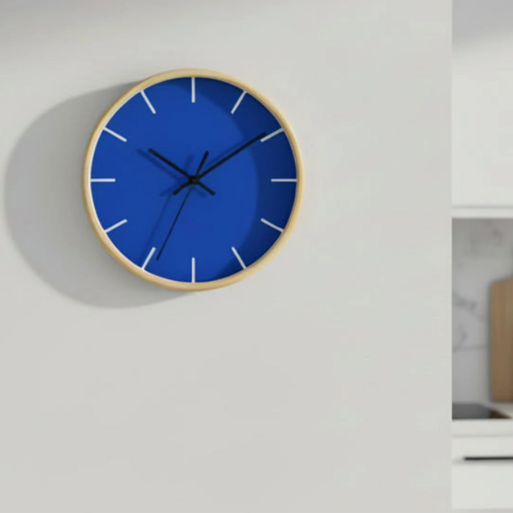 A front view of the Funky Blue silent wall clock, wooden base, black hands, white markers, 10 inch, on a wall in a minimalist kitchen.