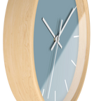 Danish blue minimalist wall clock with natural wooden base, white hands, and white markers, side view.